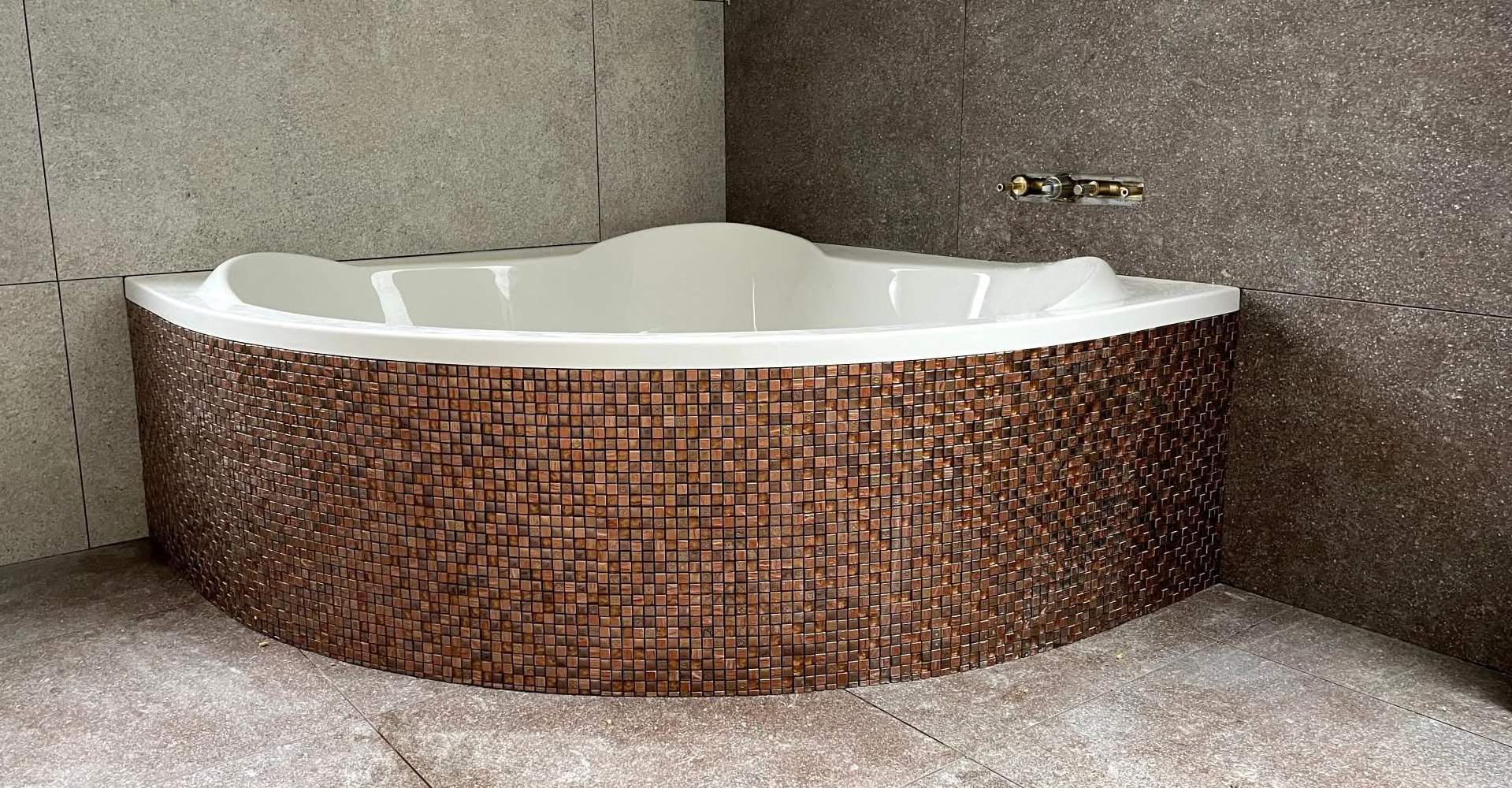 Modern bathroom with mosaic-tiled bathtub